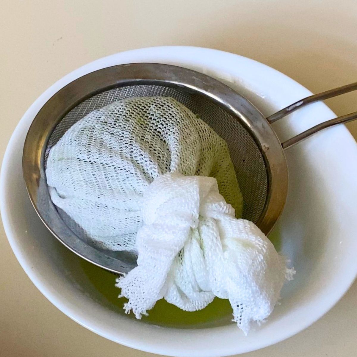 Squeezed cucumber in a cheese cloth for Tzatziki sauce.