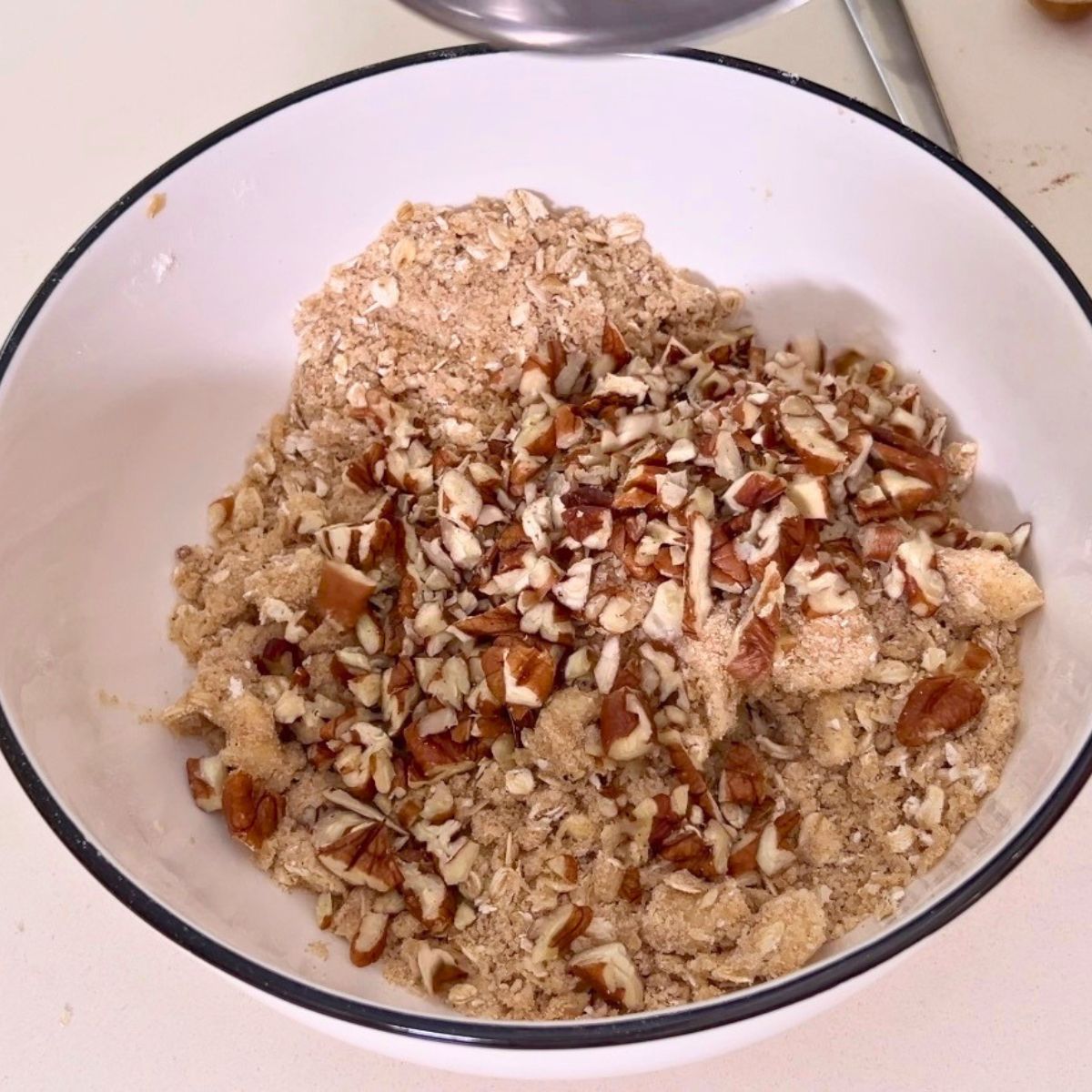 Oat streusel with pecans in a bowl.
