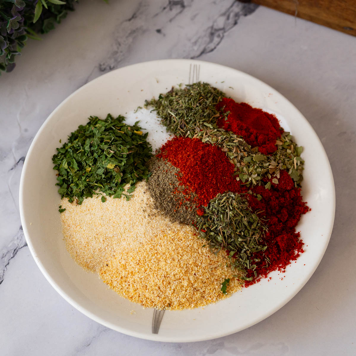A saucer with spices for all purpose seasoning.