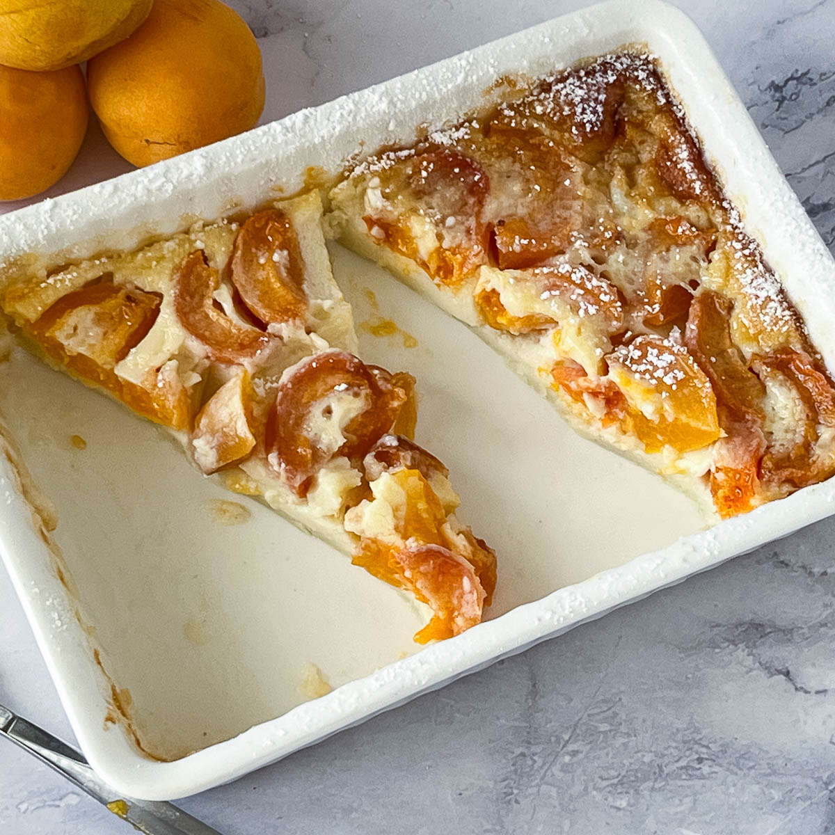 A rectangle dish with apricot clafoutis.