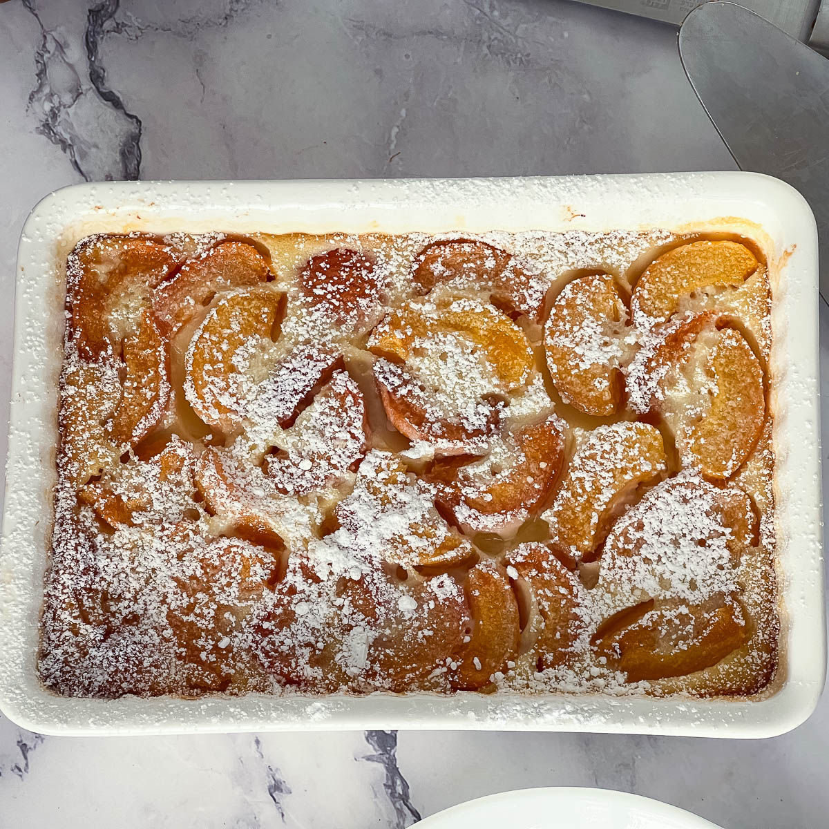 A baked clafoutis in a baking dish.
