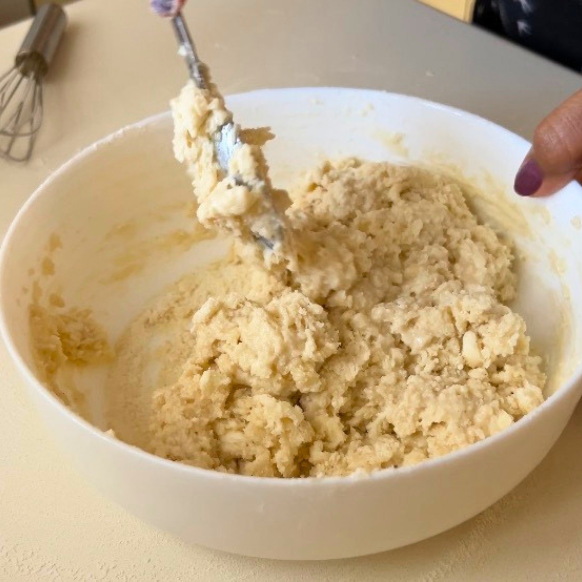A mixing bowl with cobbler topping.