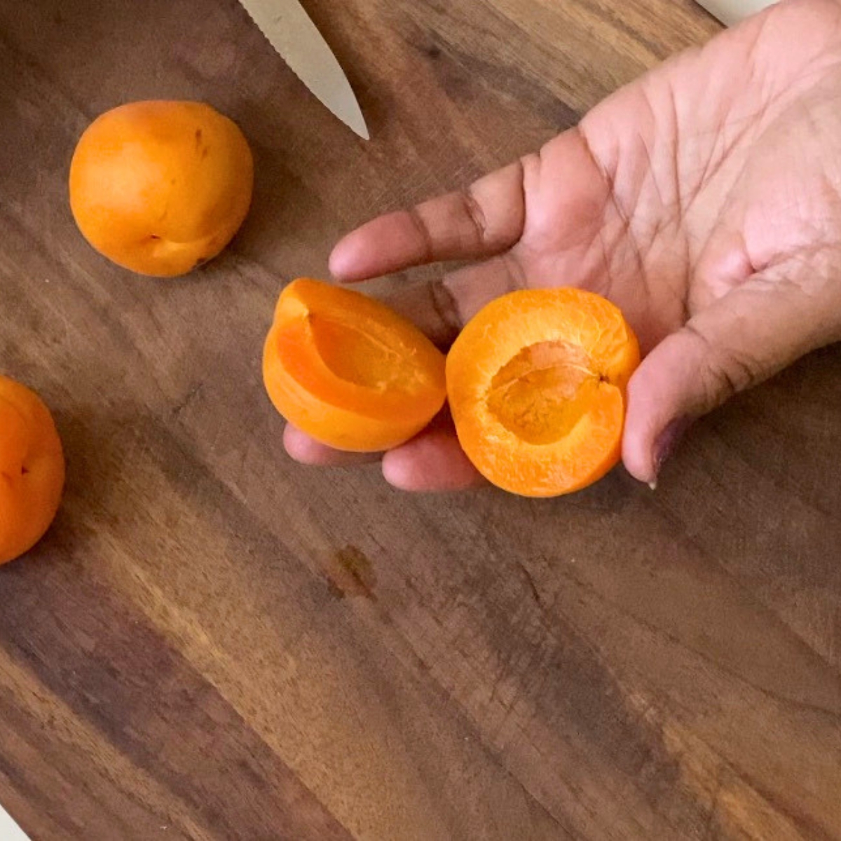 Slicing fresh apricots for the dessert.