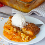 Cobbler on the plate with vanilla ice cream.