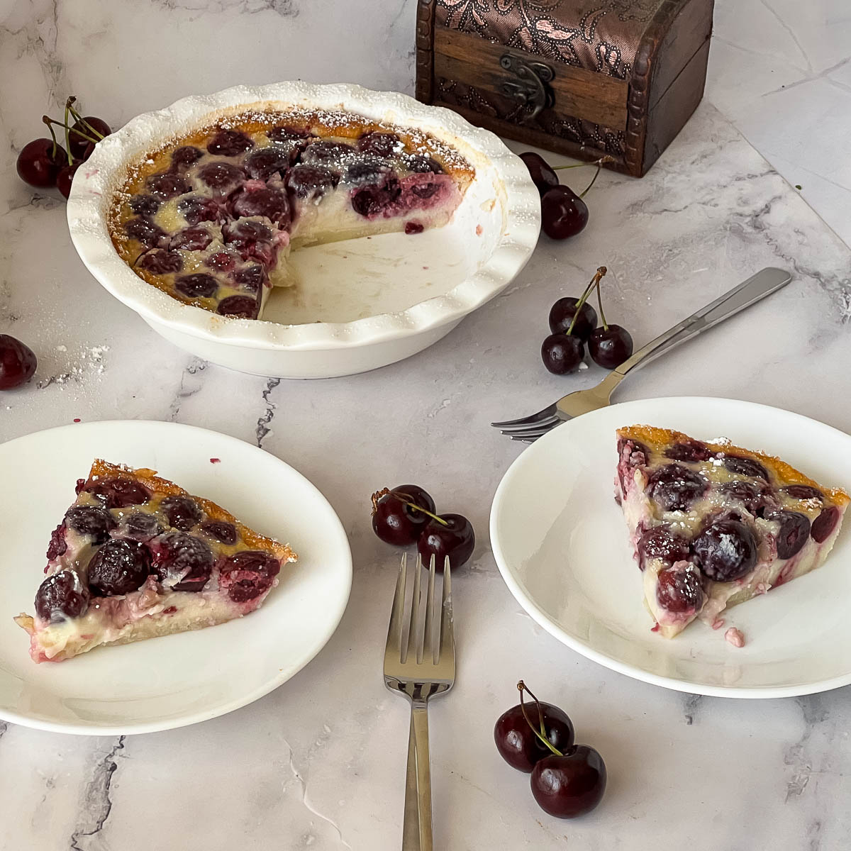 Slices of baked clafoutis on plates.