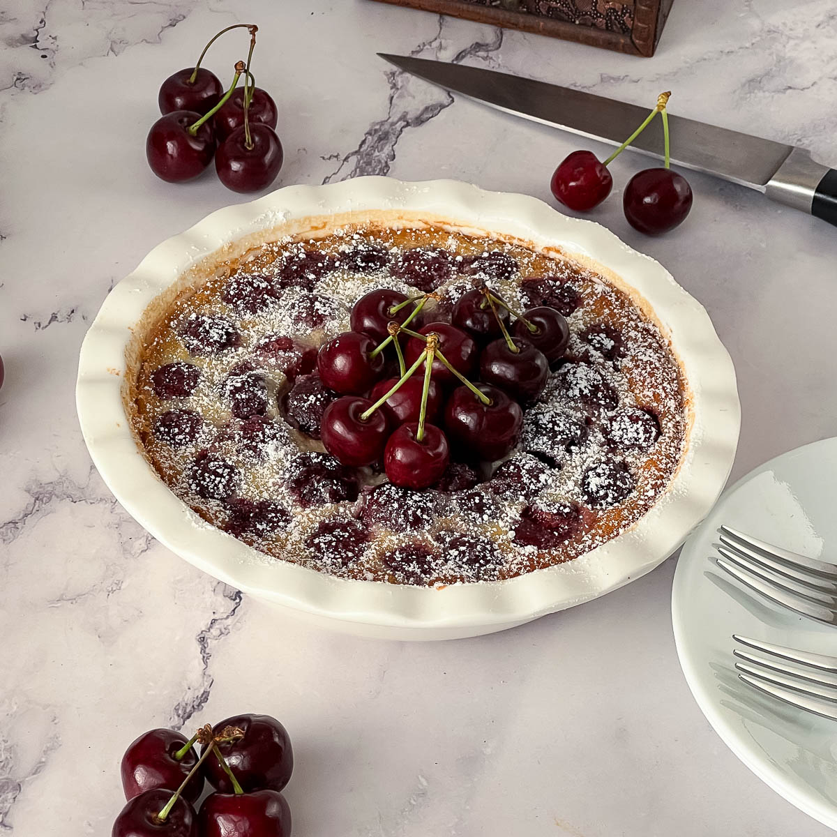 A pie pan with baked clafoutis.