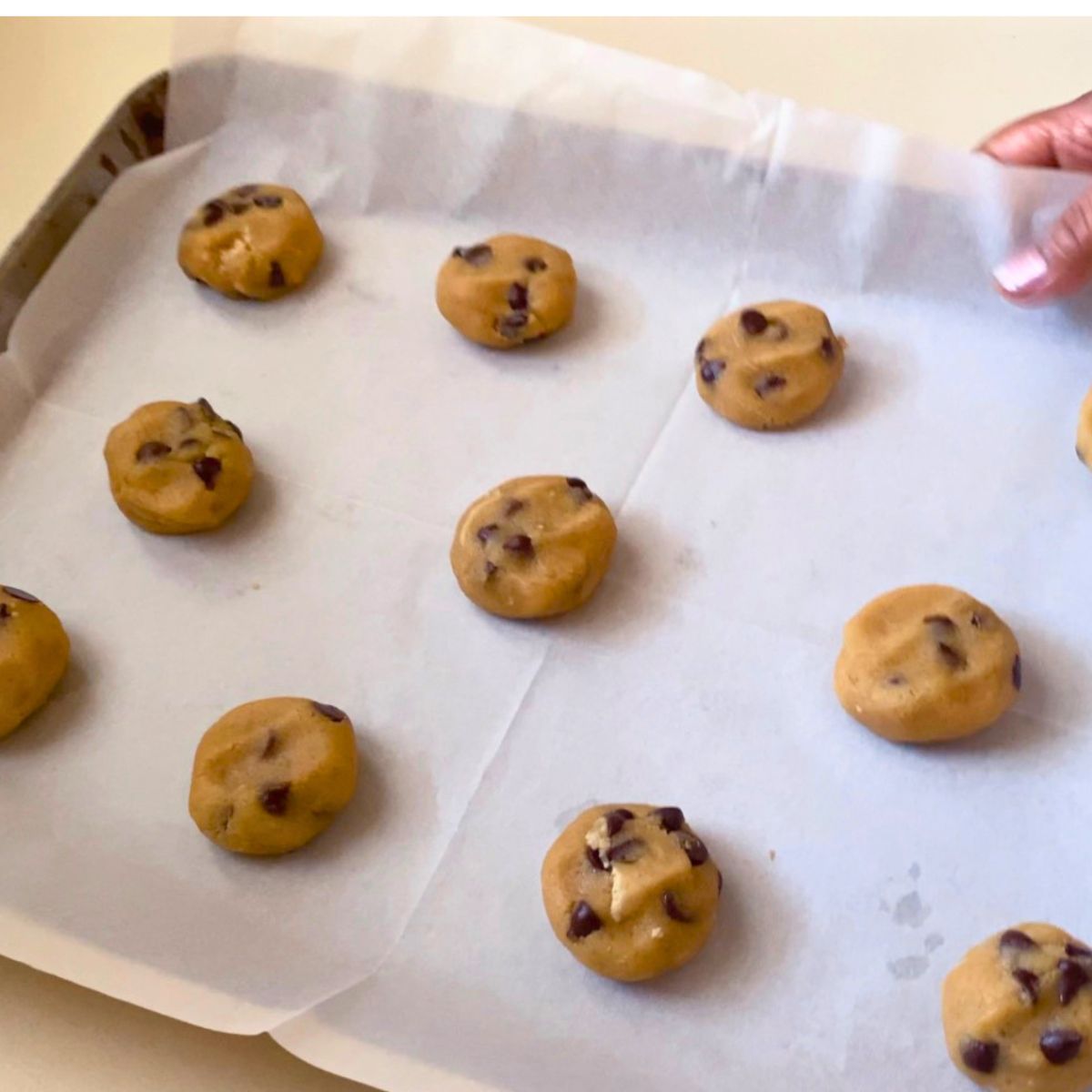 A baking tray with chocolate chip tahini cookies.