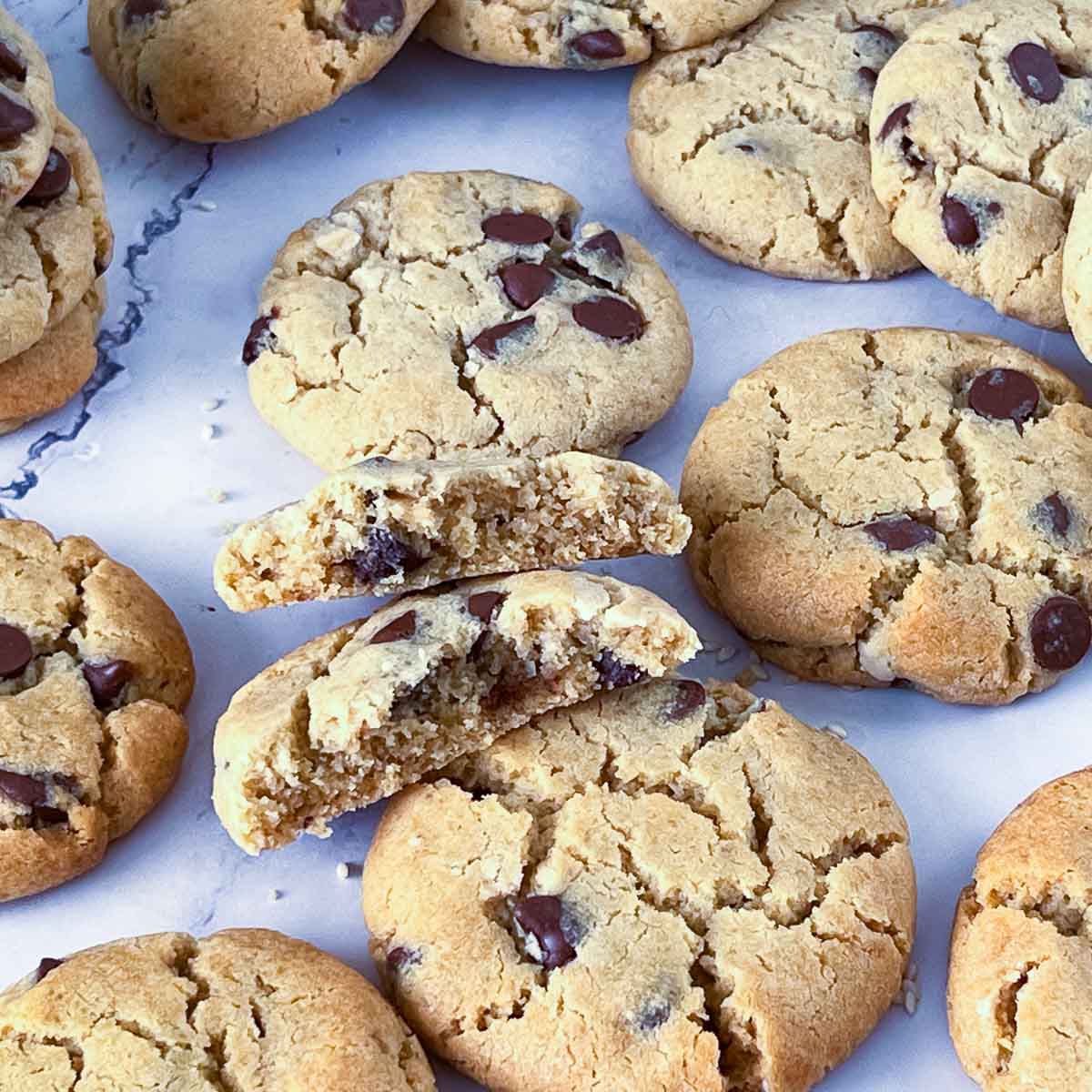 A stack of chocolate chip tahini cookies on the table.