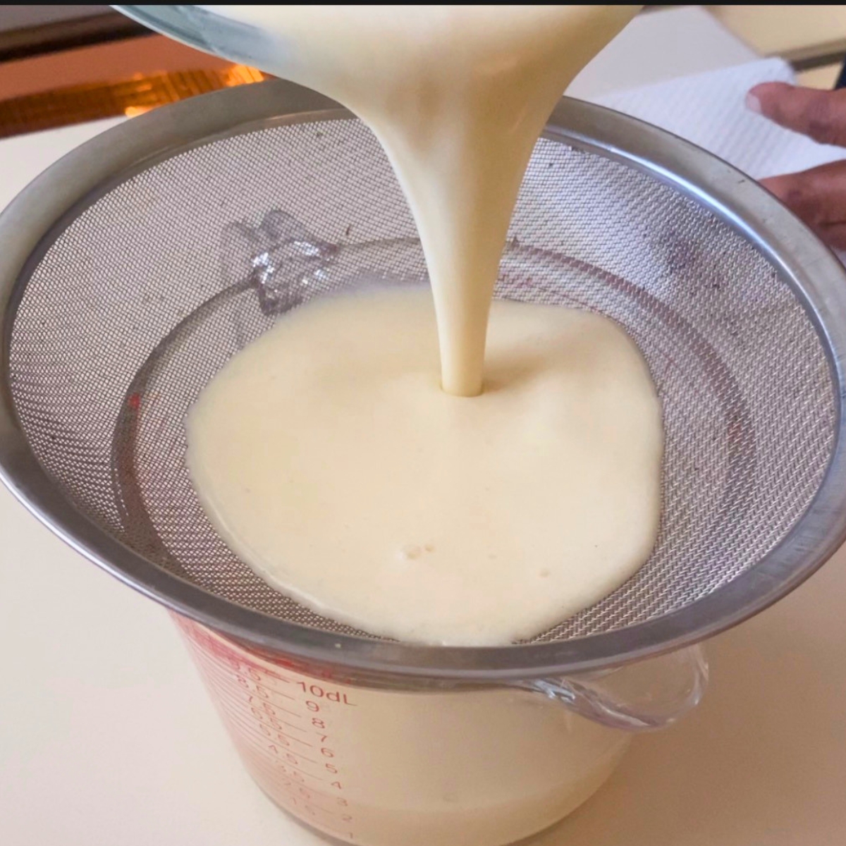 Strain the custard batter into a glass dish.