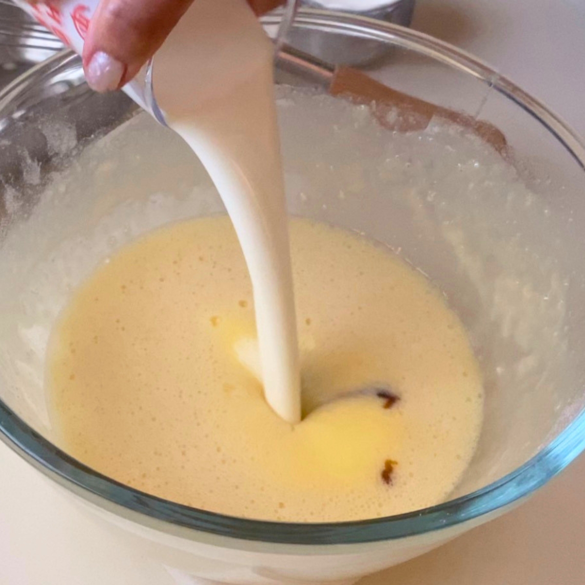 A glass dish with custard mixture.