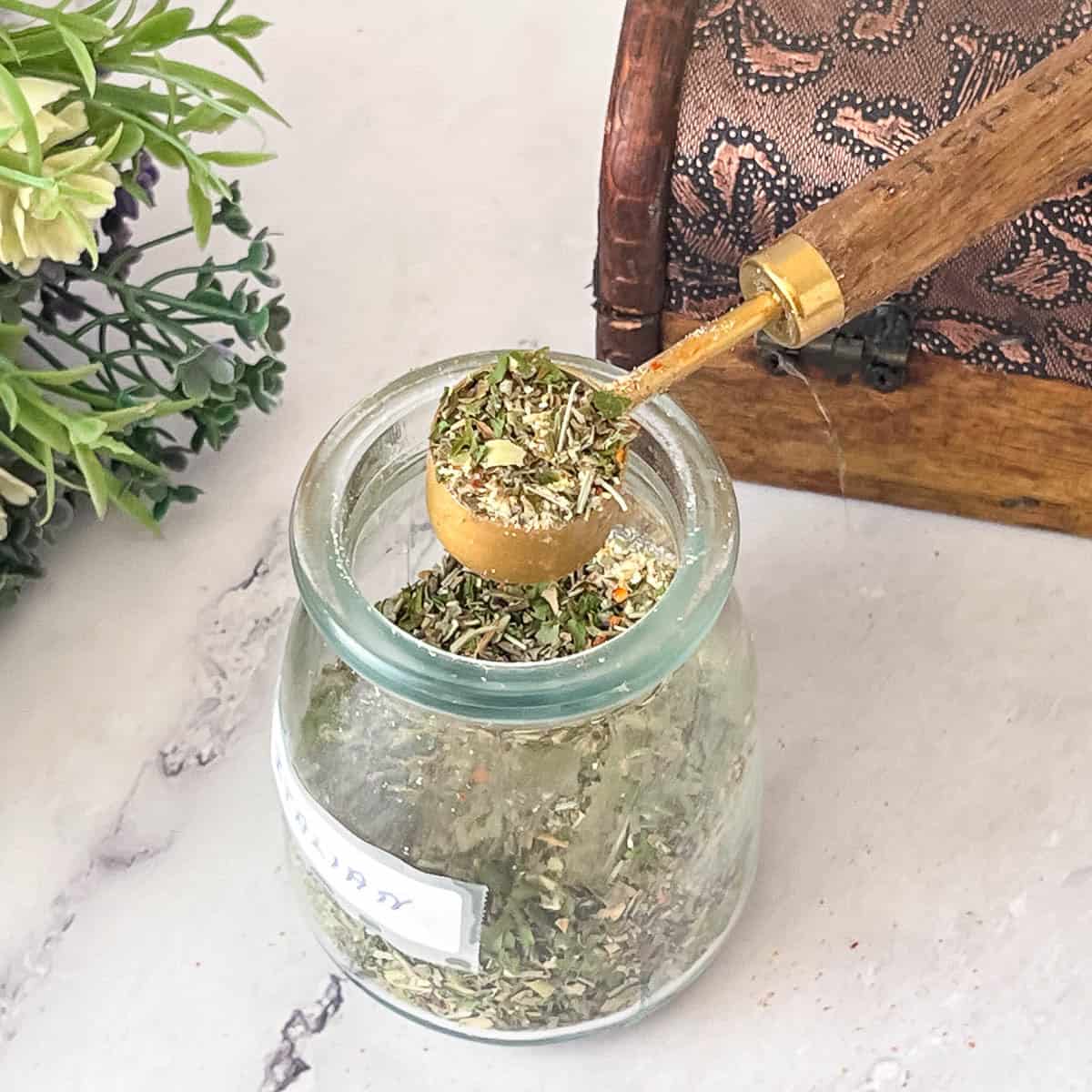 A jar with spice mix Italian seasoning.