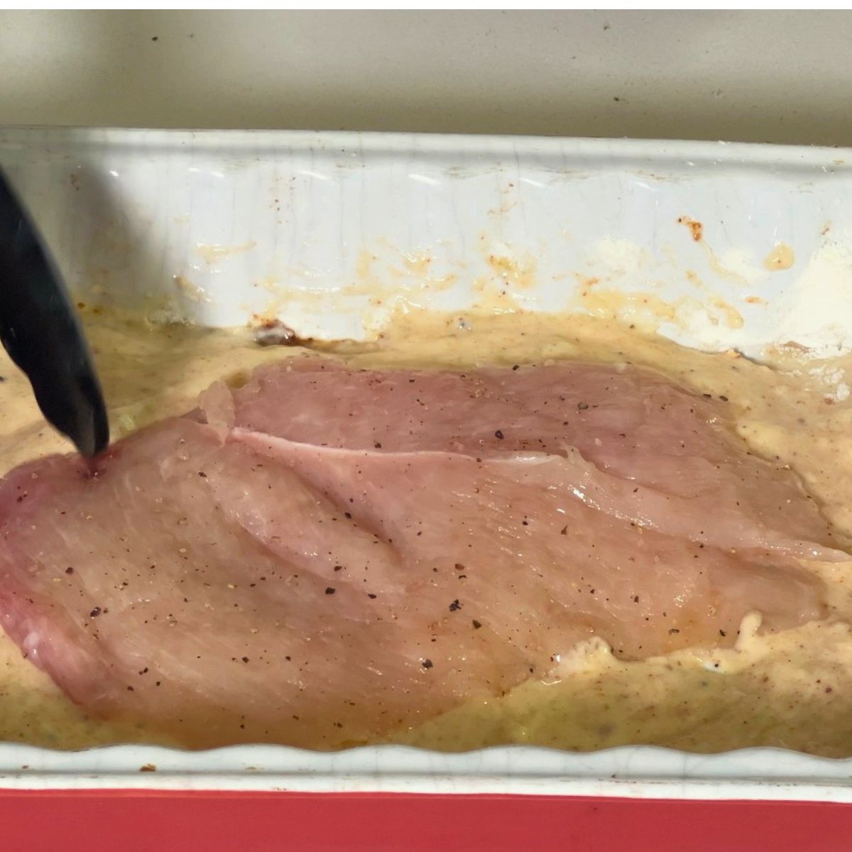 A dish with chicken breast in egg yogurt batter.