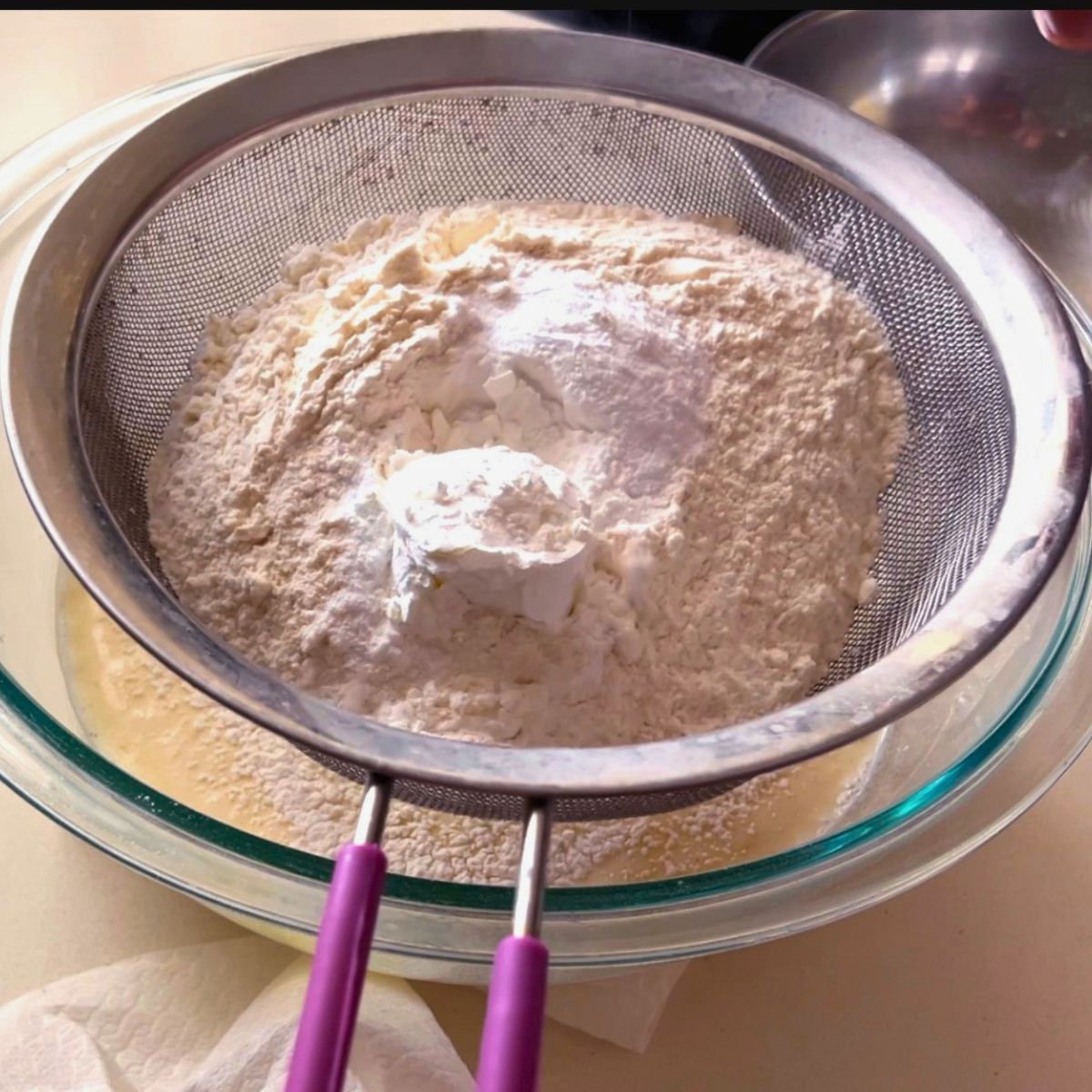 Adding dry ingredients to the waffle batter.