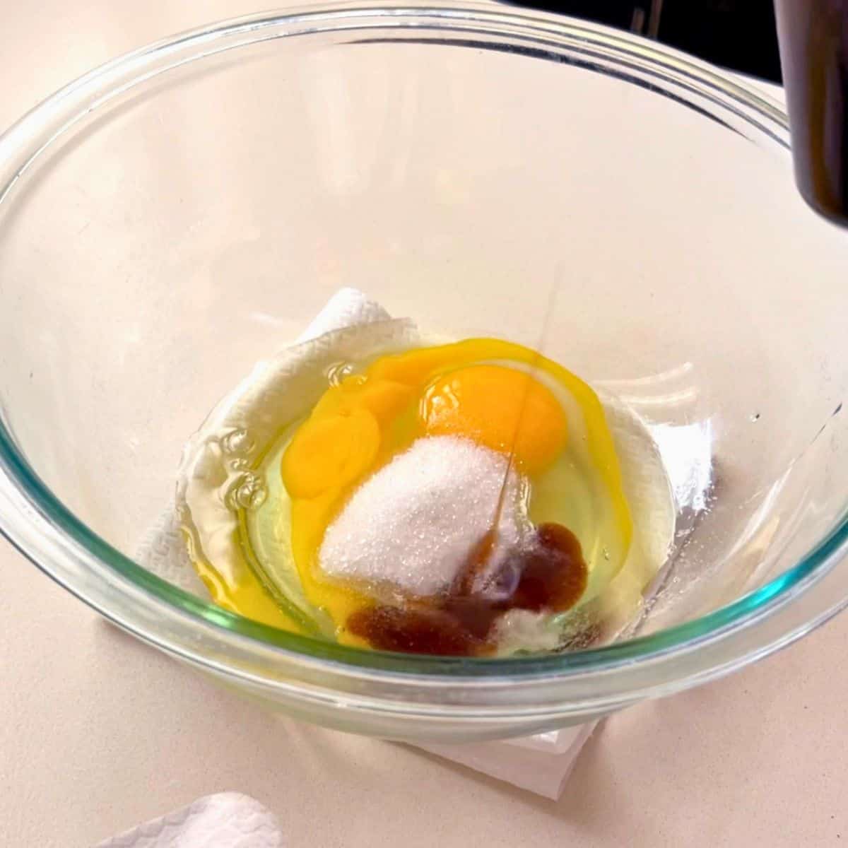 A glass bowl with ingredients for waffles.
