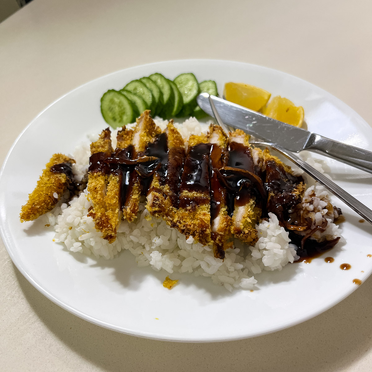 Baked crispy chicken breast over steamed rice.