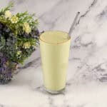 A tall glass with matcha smoothie.