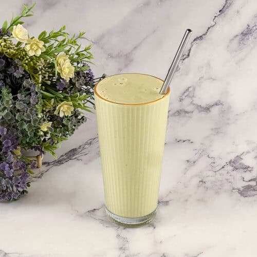 A tall glass with matcha smoothie.