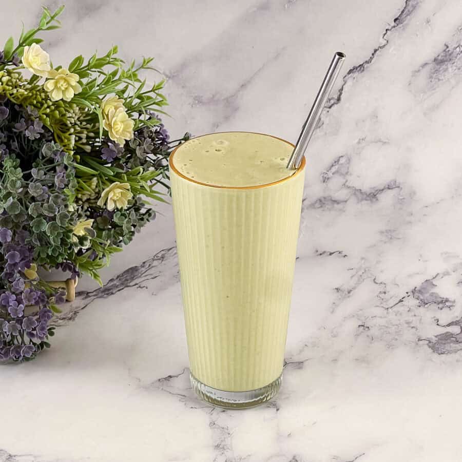 A tall glass with matcha smoothie.