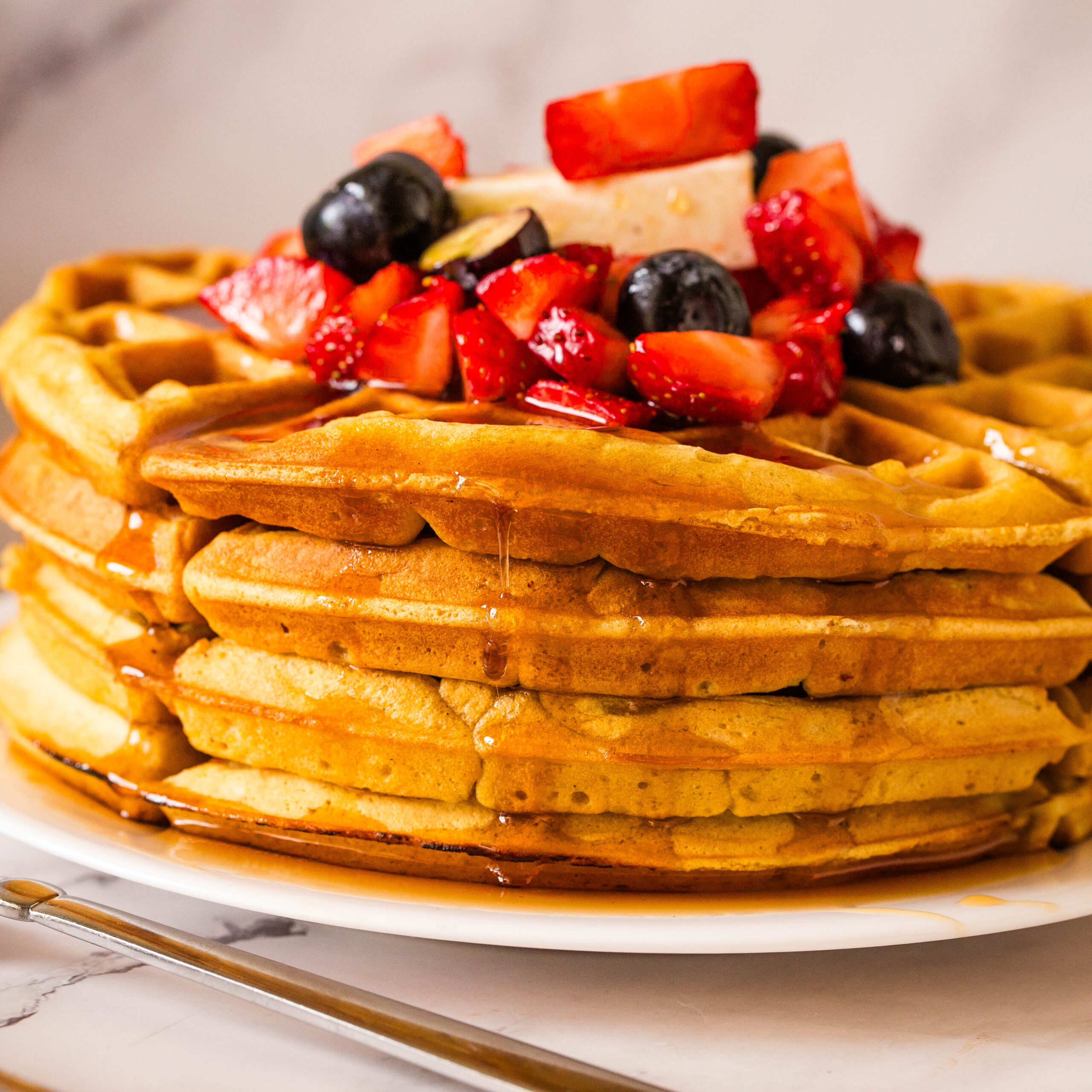 Honey drizzle down the stack of waffles.