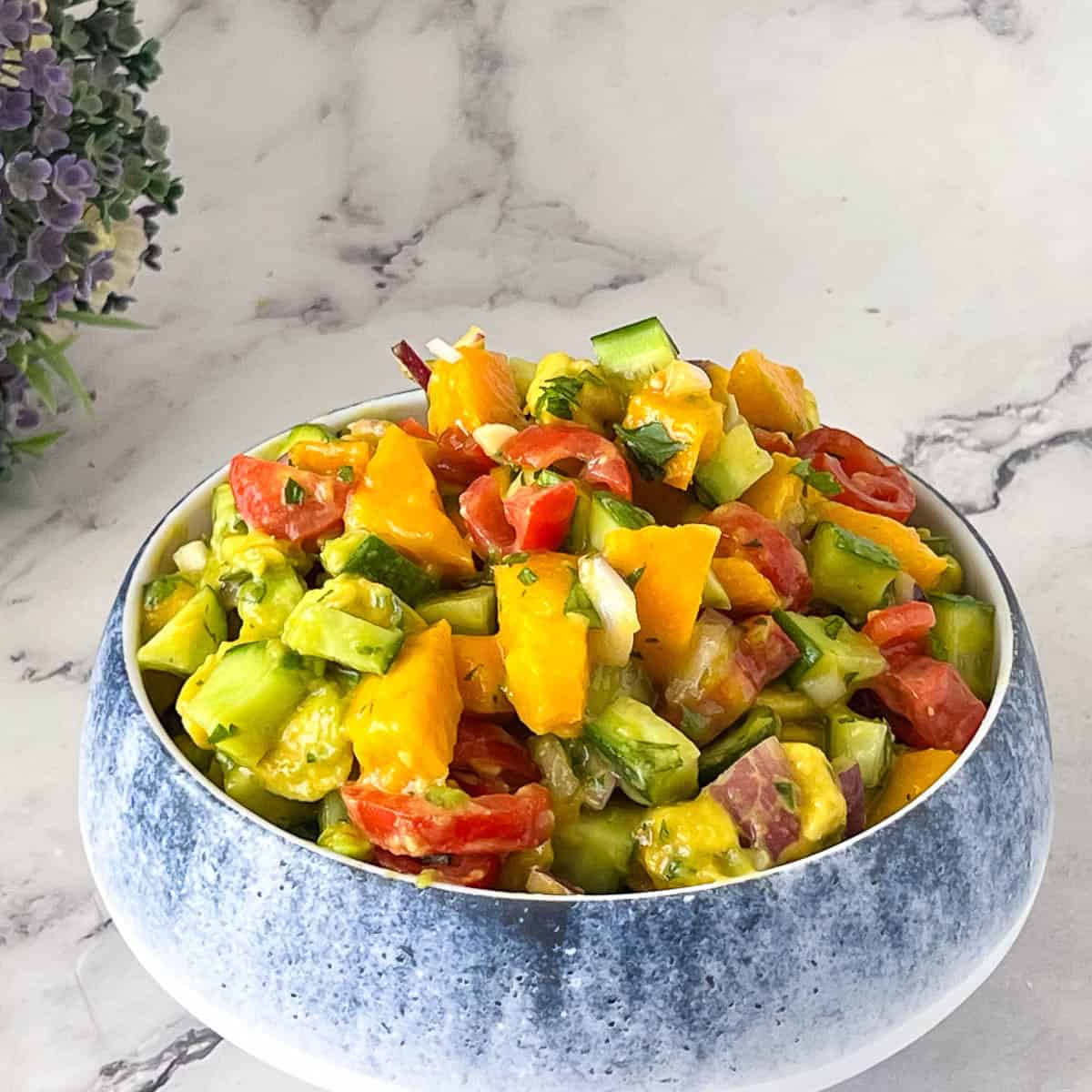 Bowl with mango salad and lime dressing.