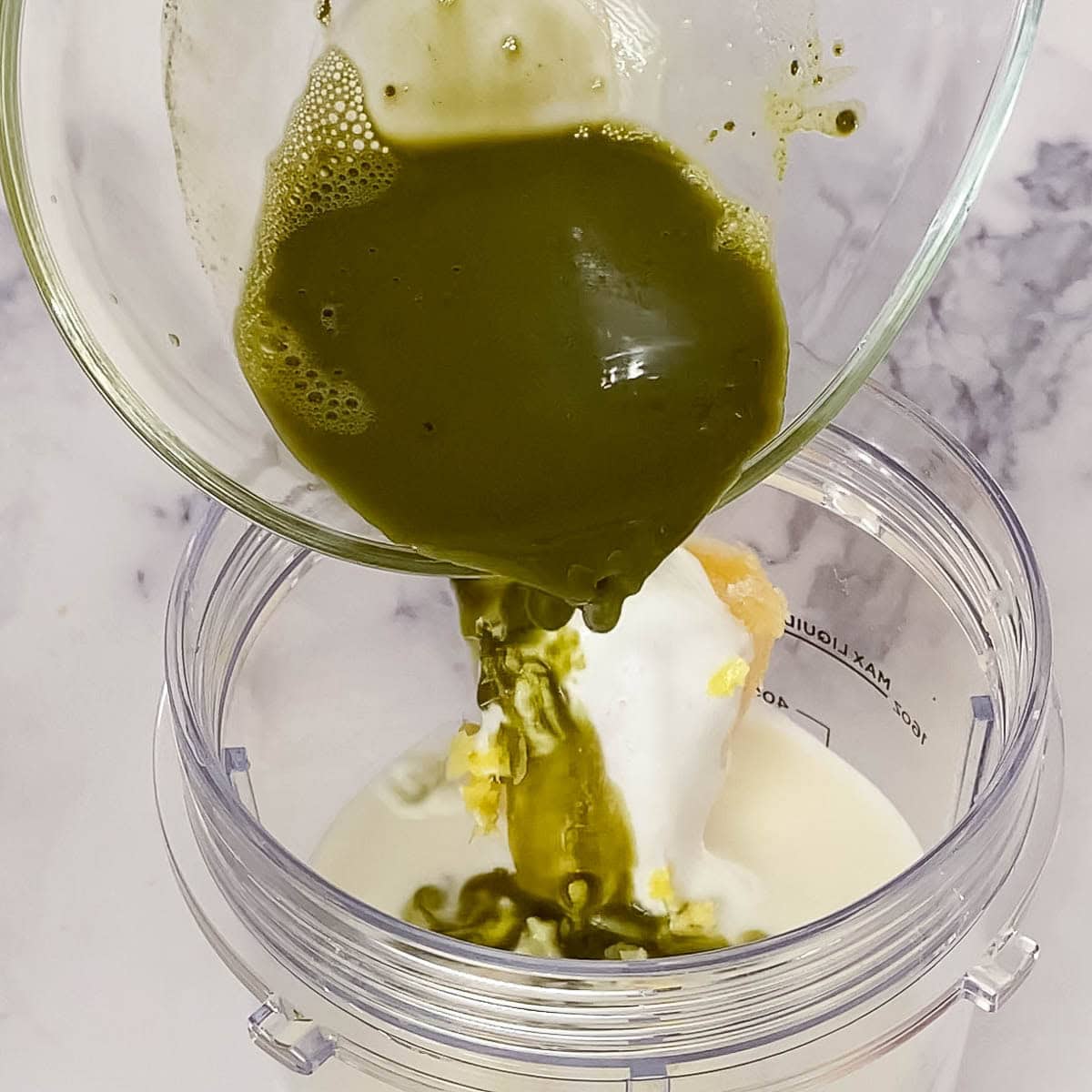 Pouring matcha into the blender.