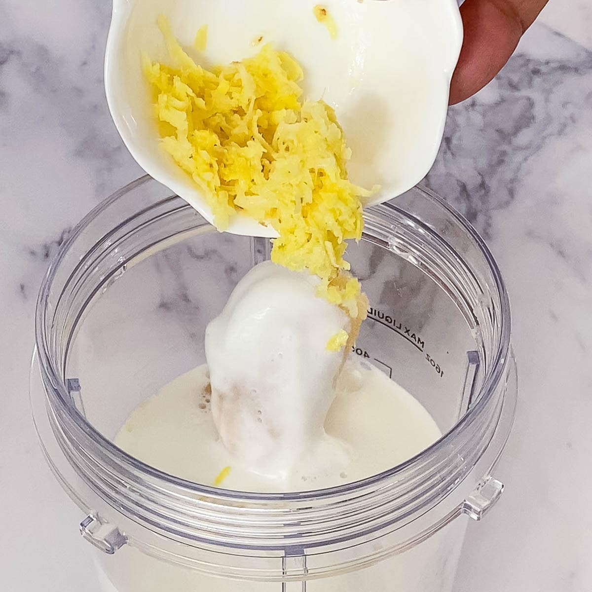 Adding ginger to the blender.