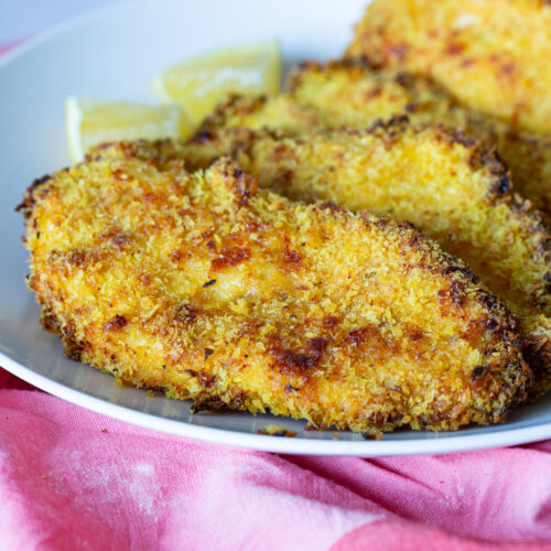 A plate with crispy baked chicken breast.
