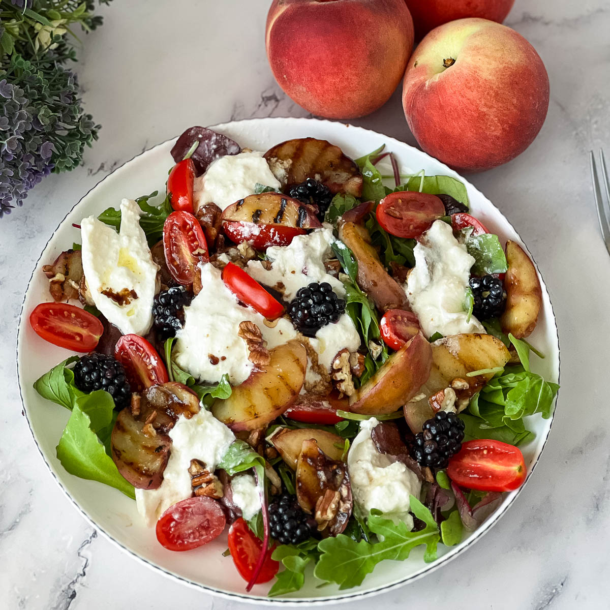 A peach burrata salad with grilled peaches.