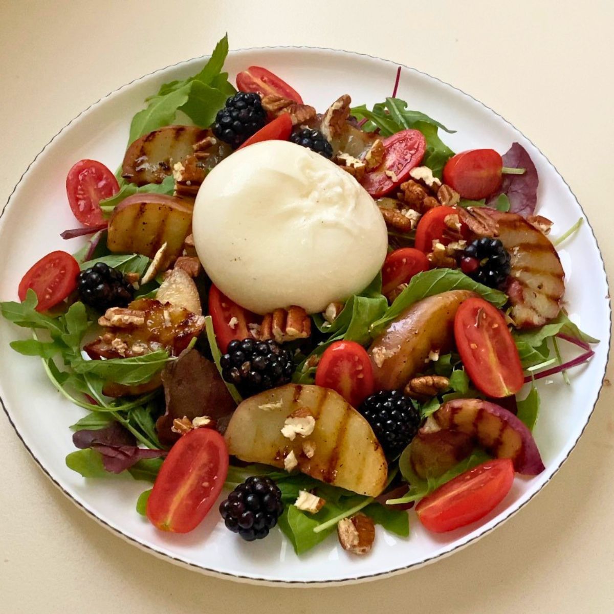 A fresh salad with fresh burrata salad.