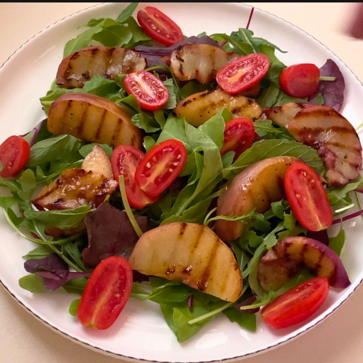 A white plate with fresh salad.