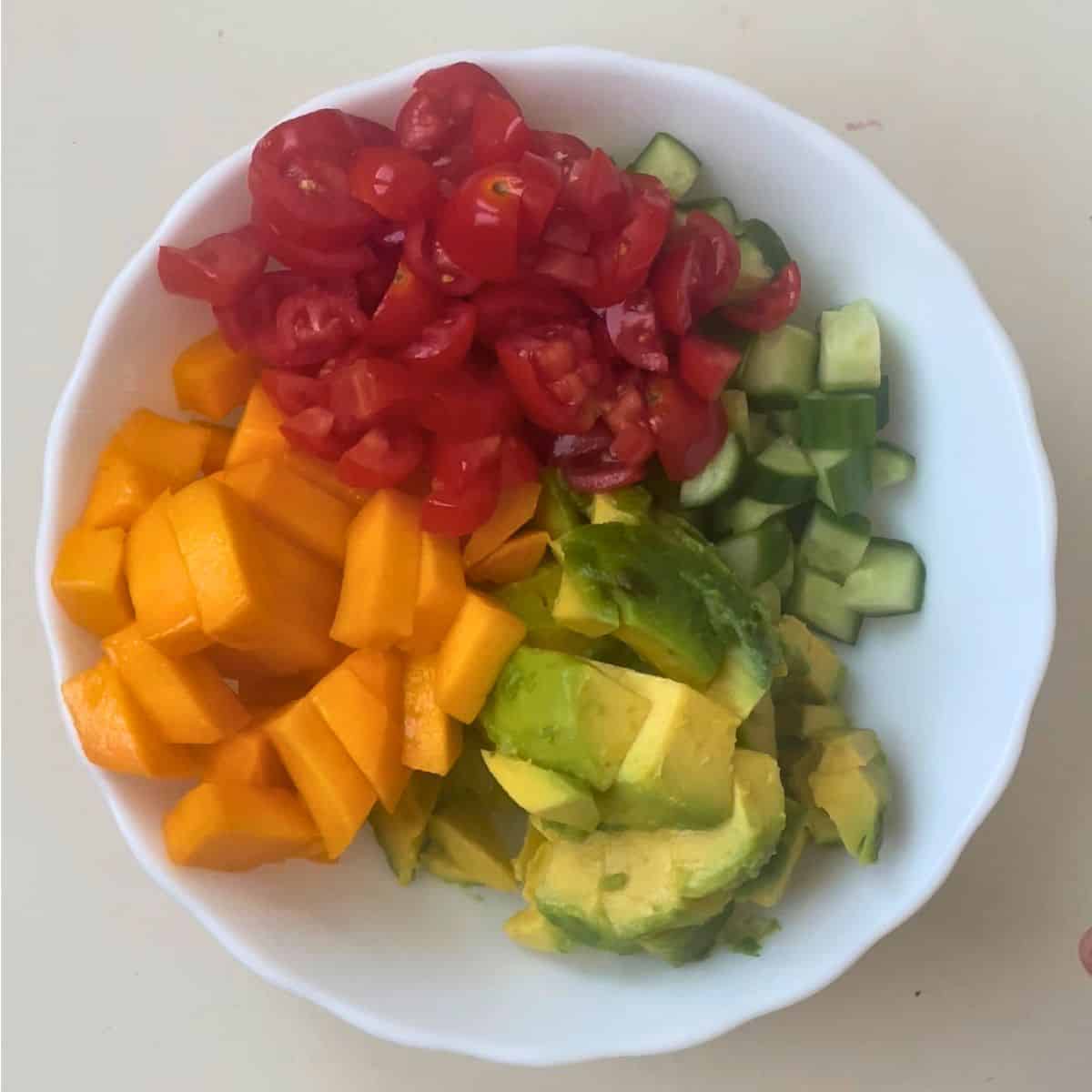 Salad veggies in a white bowl.