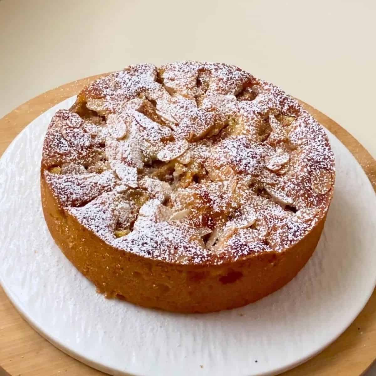 Almond cake with fresh figs sliced on the table.