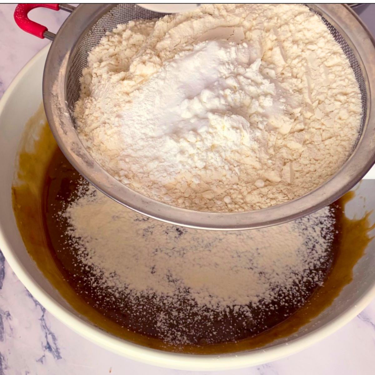 Adding flour to cookie dough.