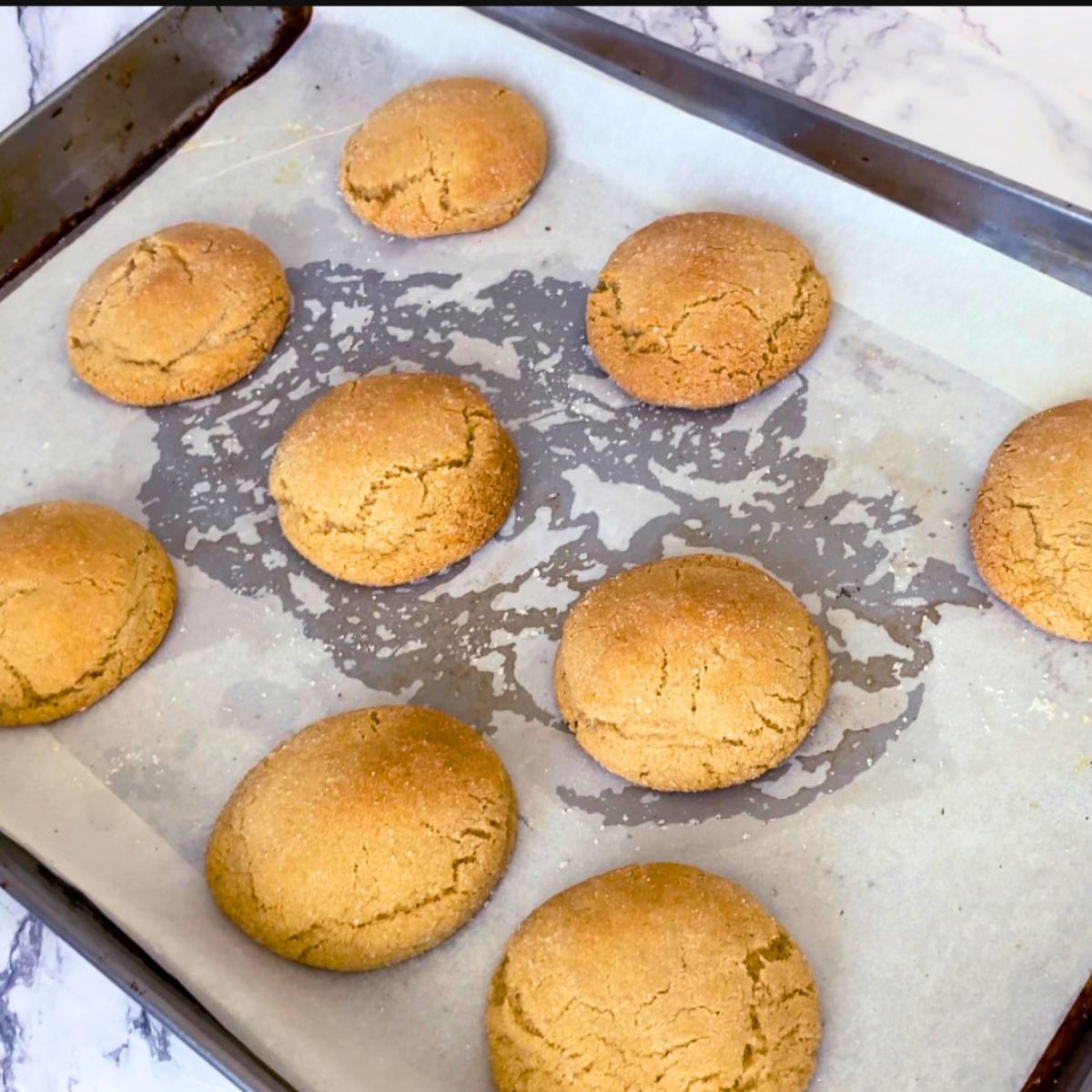 Freshly baked chewy brown sugar cookies on a baking sheet.