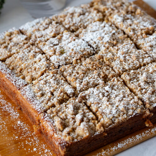 A sliced coffee cake on the wooden board.