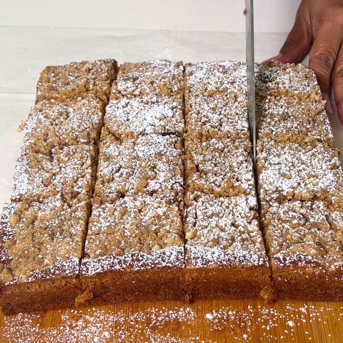Cutting the coffee cake into squares.