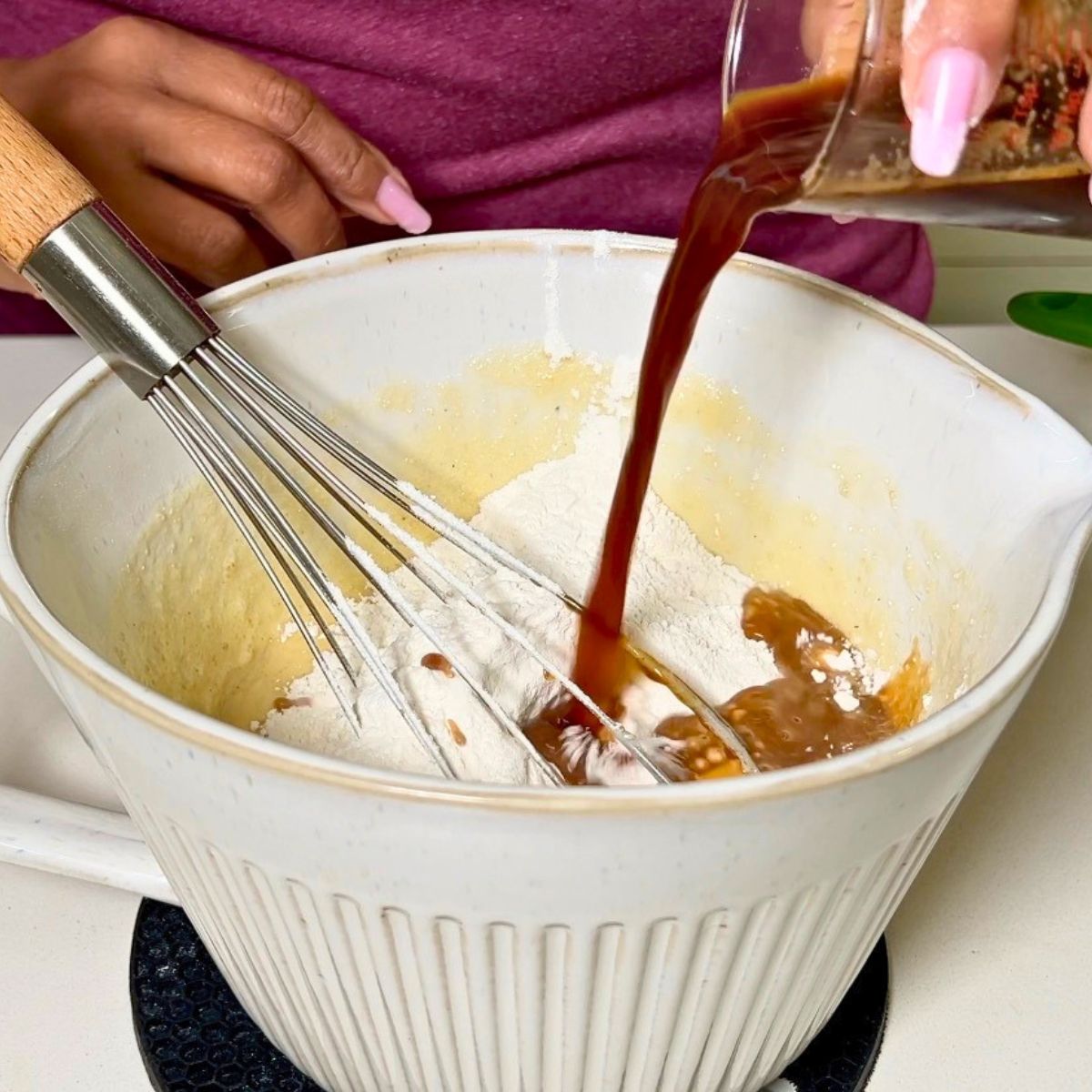 Adding coffee to the cake batter.