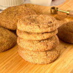 A stack of pumpkin cookies on the table.
