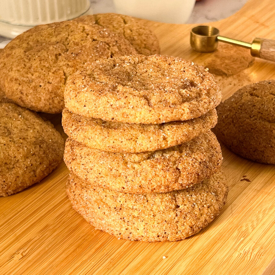 A stack of pumpkin cookies on the table.