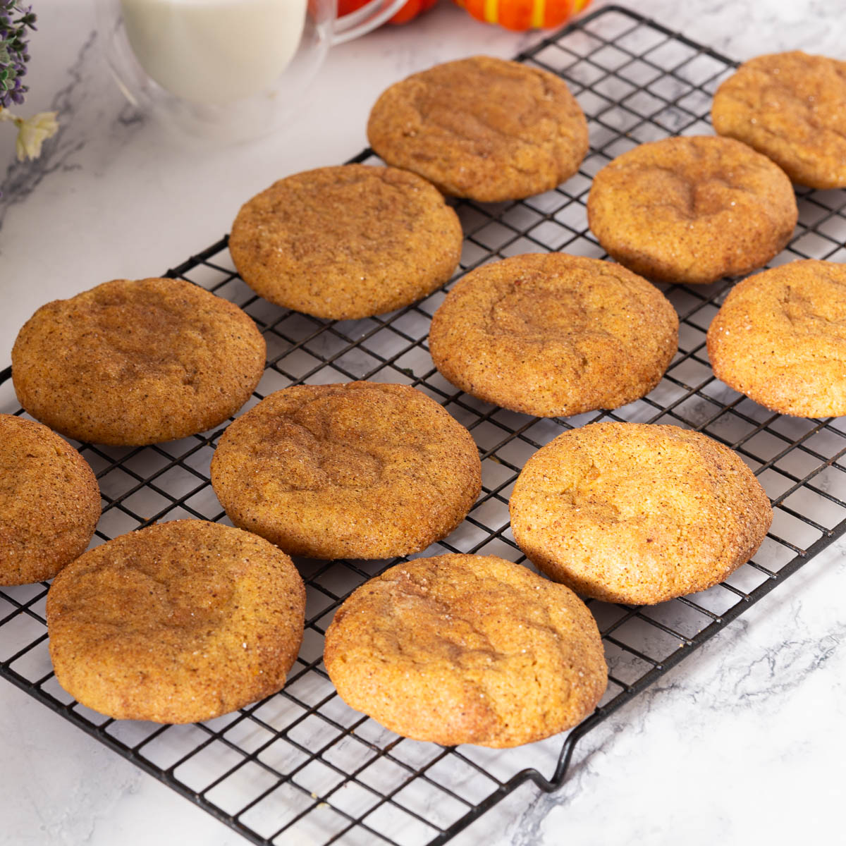 A wire rack with pumpkin cookies.