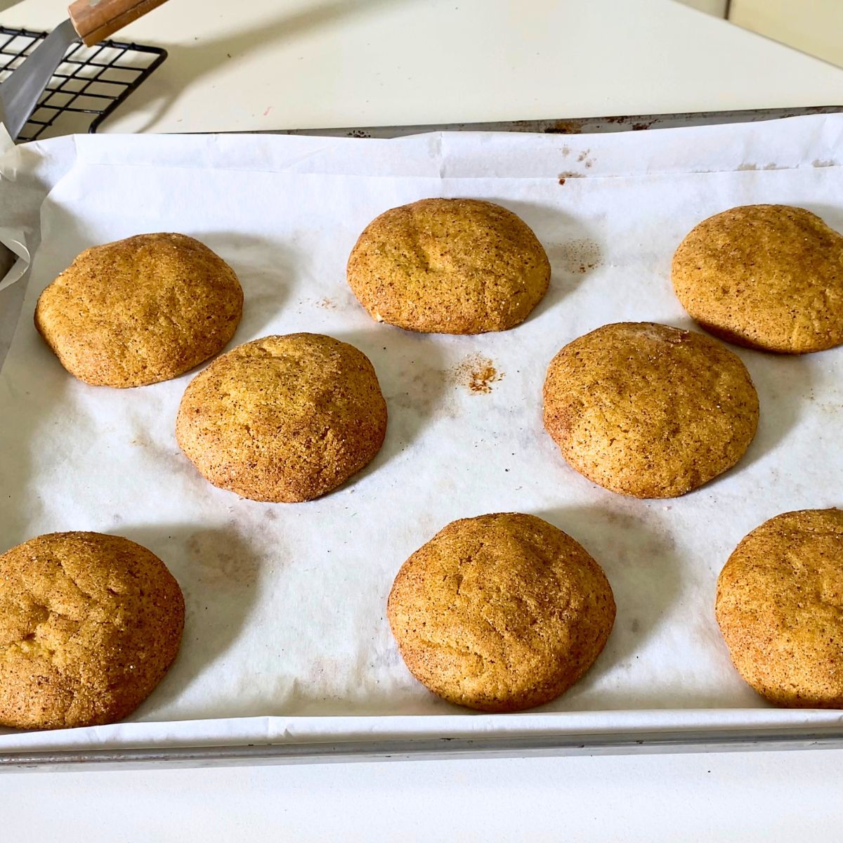 Fresh baked pumpkin cream cheese cookies on the baking tray.