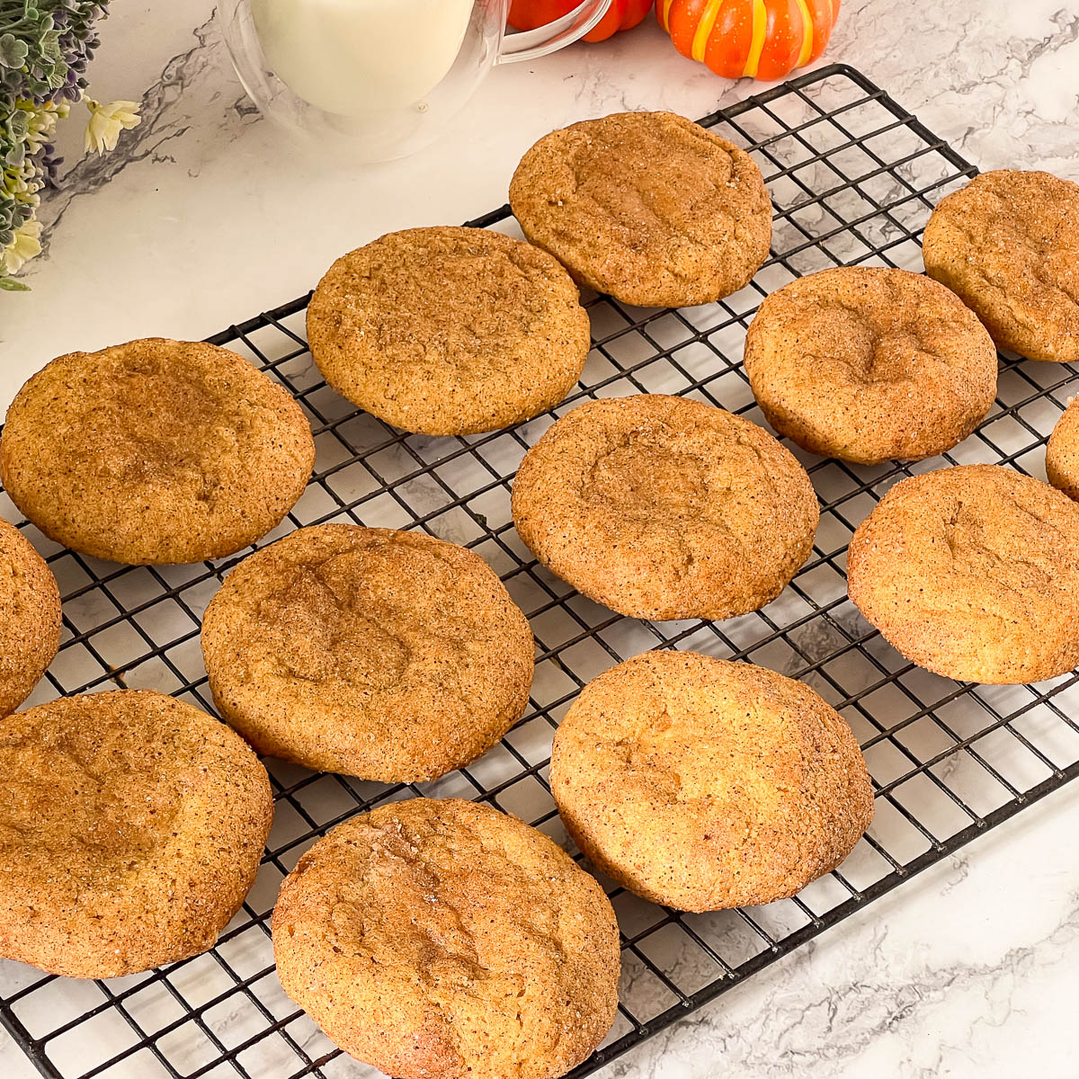 Wire rack with baked pumpkin cream cheese cookies.
