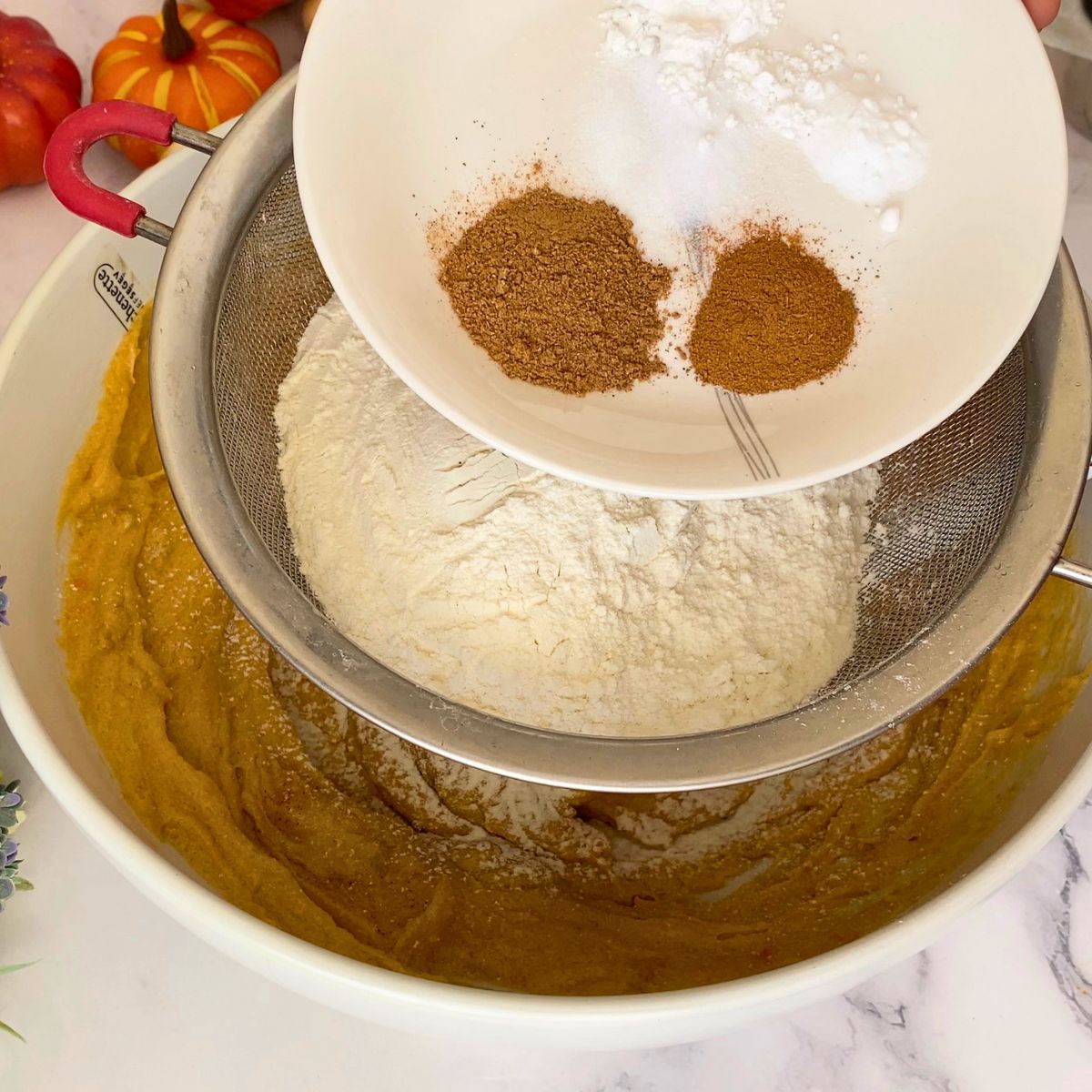 Adding flour to the cookie dough.