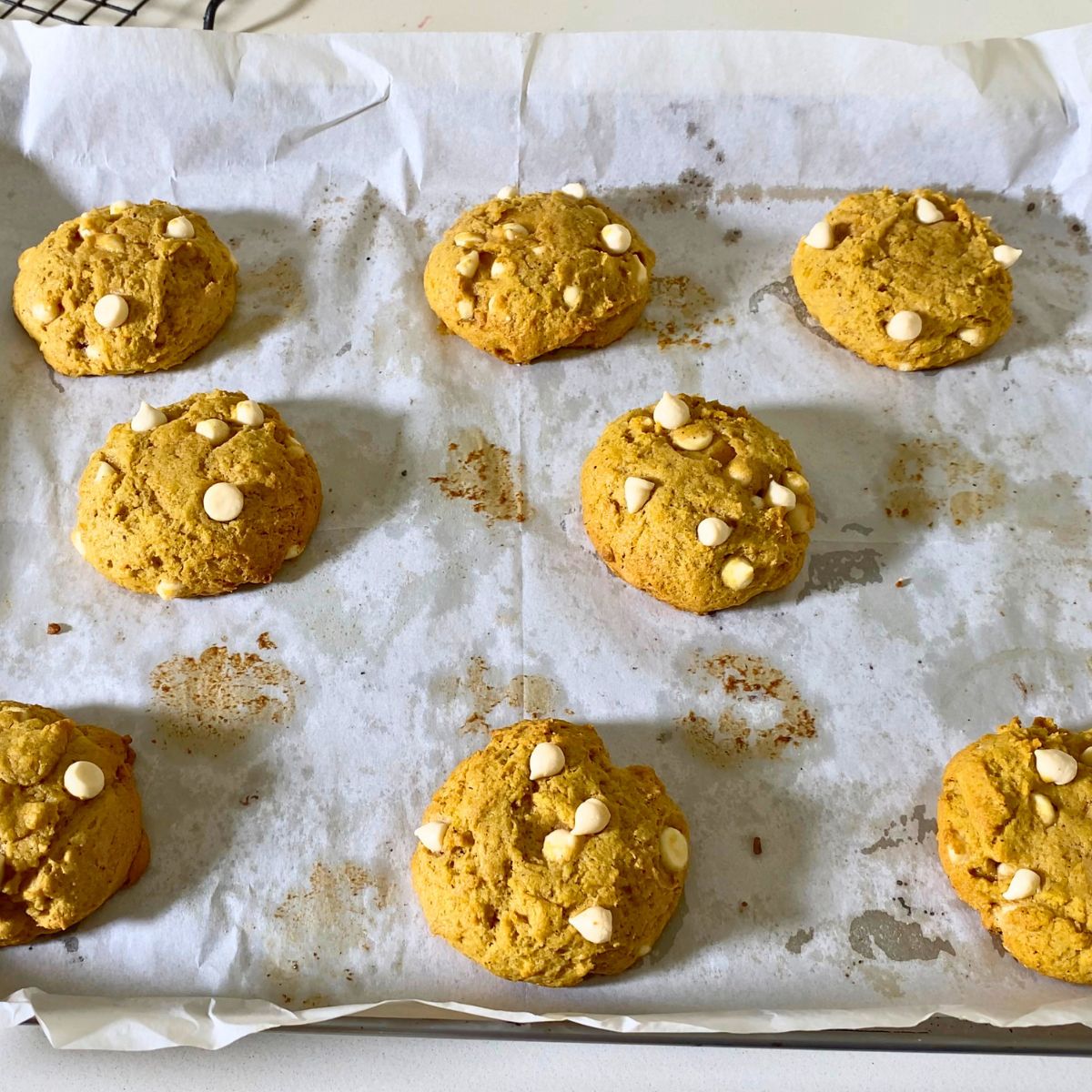 Baking tray with white chocolate pumpkin cookies.