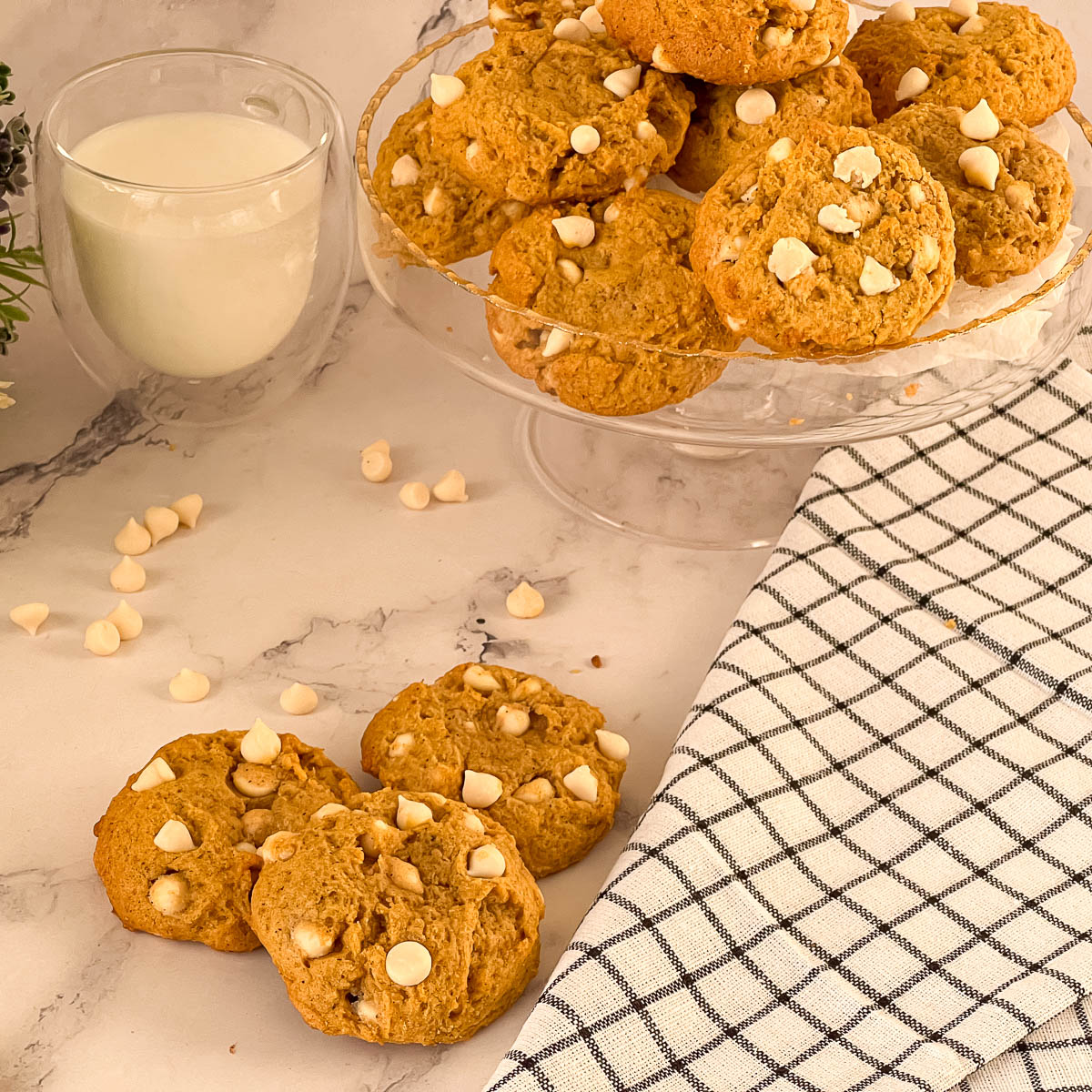 Pumpkin cookies with chocolate chips on the table.