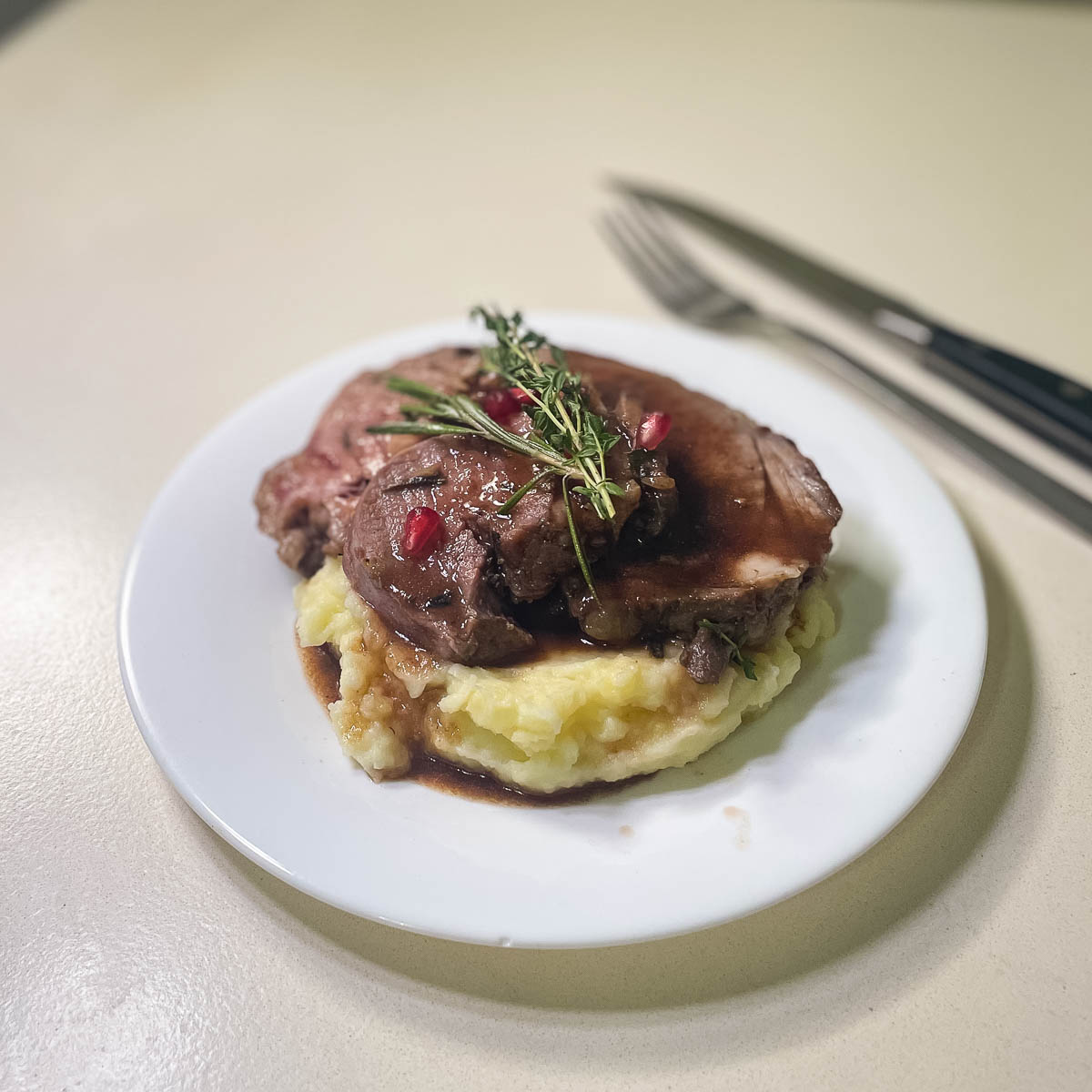 Lamb roast over mashed potatoes.