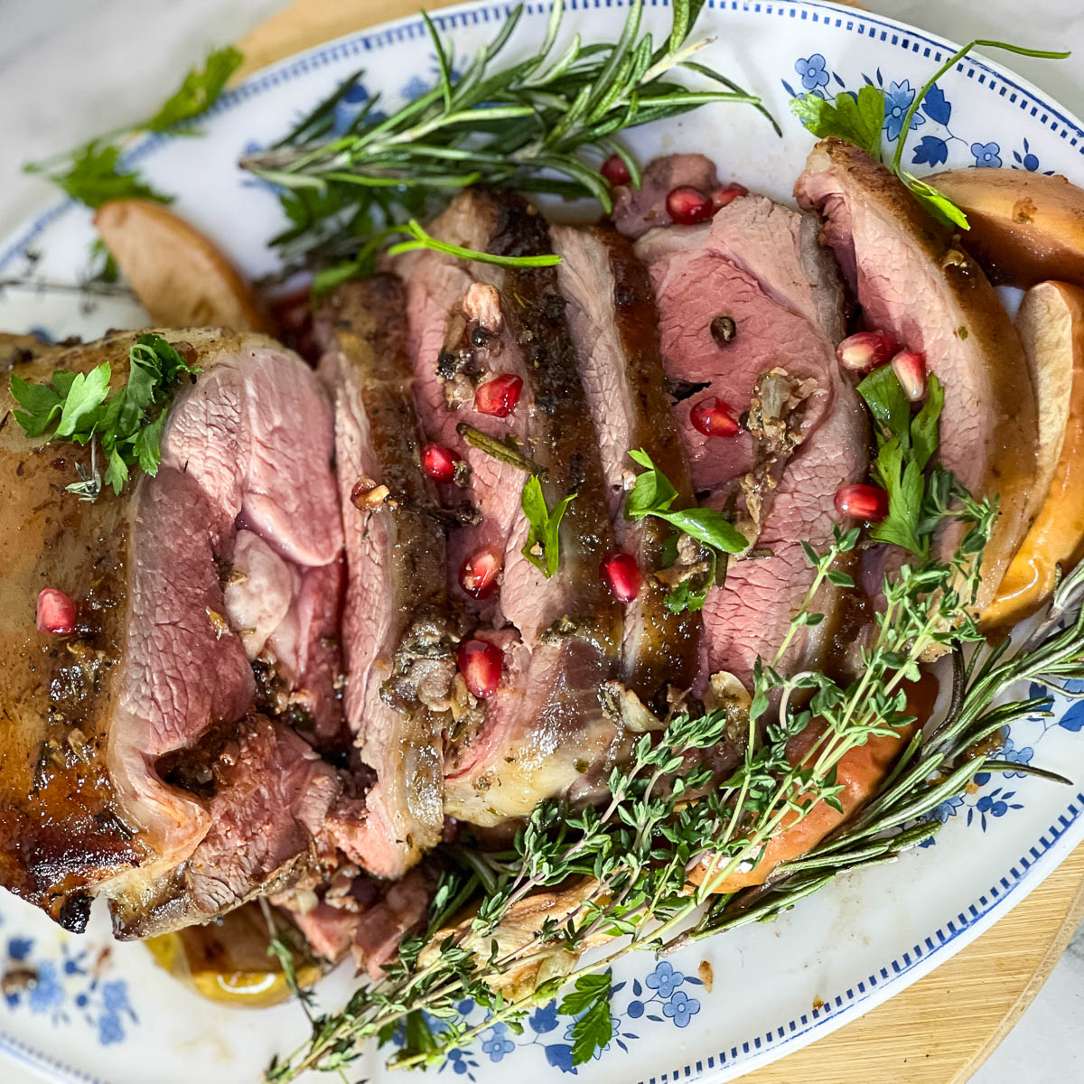Sliced lamb roast on a platter.