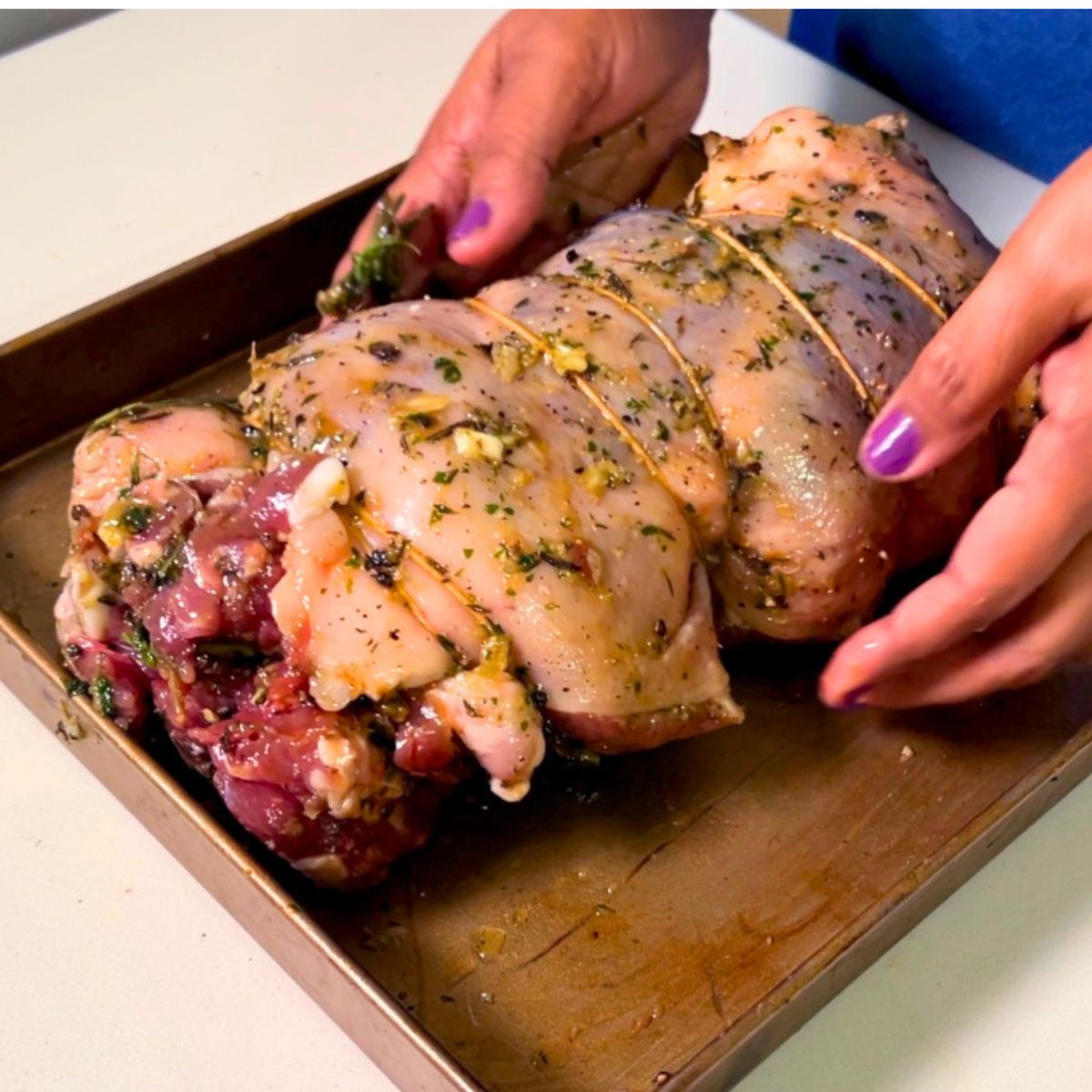 Tying the lamb for roasting.