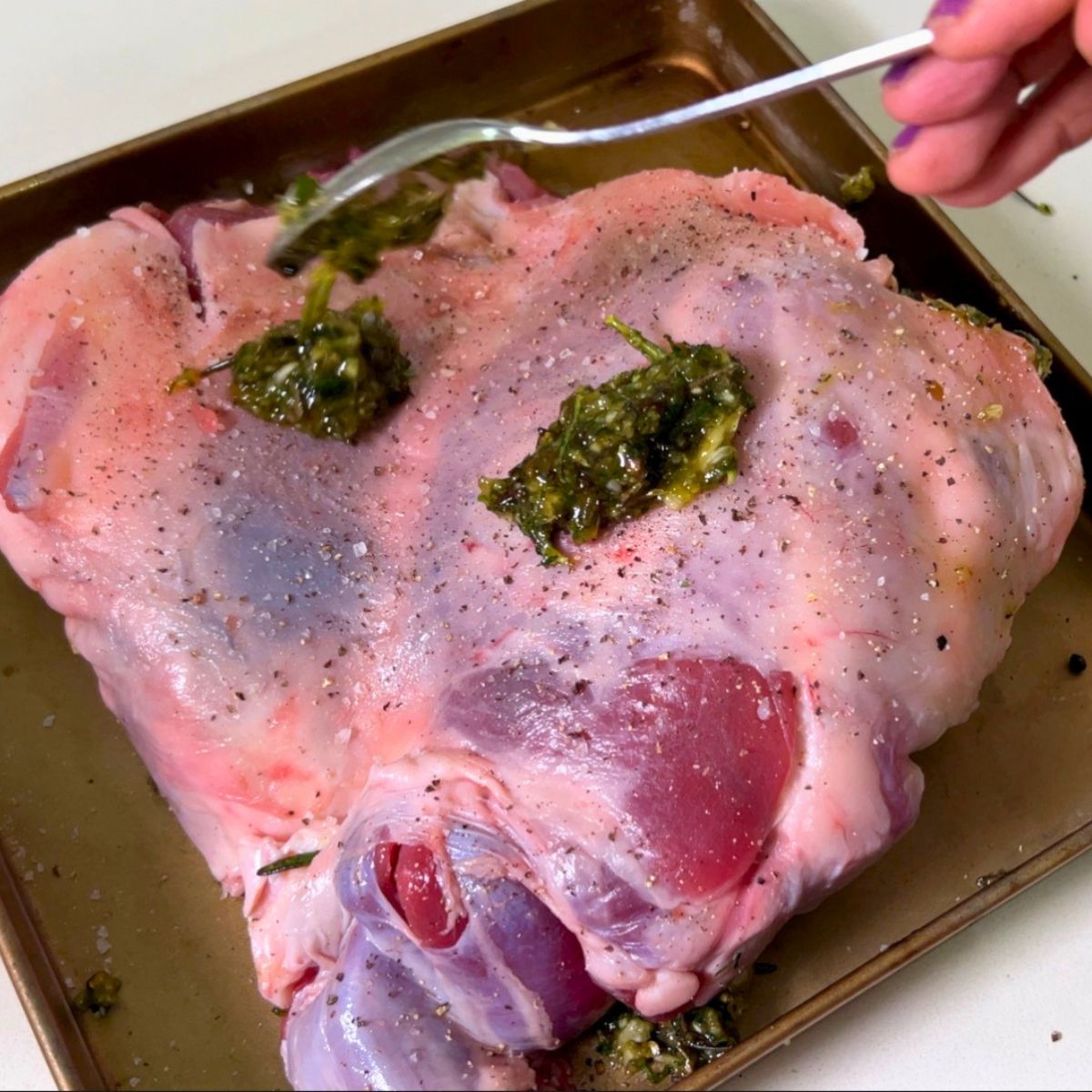 Rub the marinade over the roast lamb.