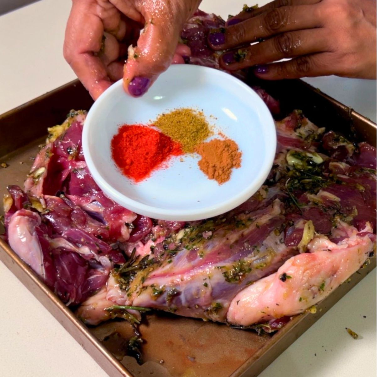 Add spices to the roast lamb.